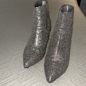 These silver shiny shoes by sugar are size 8m.